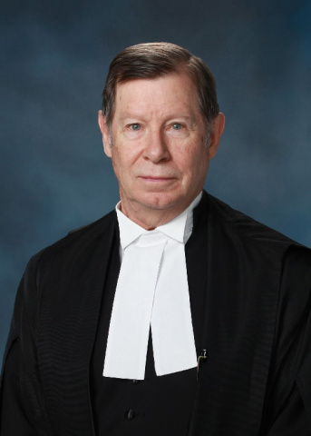 White man in black and white judicial robes.