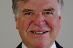 Man wearing a dark suit and tie.